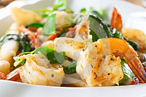 Closeup of Spicy fried seafood with shrimp in white dish