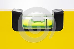 closeup of spirit level tool in yellow isolated on white background