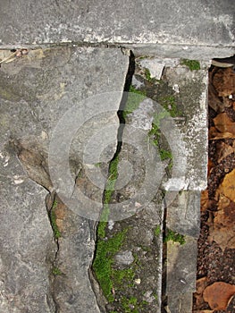 Closeup split, cracked layers of old masonry, limestone. facing plates in an architectural structure.