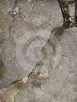 Closeup split, cracked layers of old masonry, limestone. facing plates in an architectural structure.