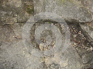 Closeup split, cracked layers of old masonry, limestone. facing plates in an architectural structure.