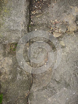 Closeup split, cracked layers of old masonry, limestone. facing plates in an architectural structure.