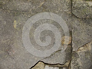 Closeup split, cracked layers of old masonry, limestone. facing plates in an architectural structure.