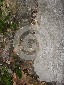 Closeup split, cracked layers of old masonry, limestone. facing plates in an architectural structure.