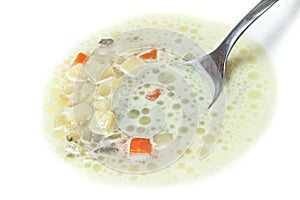 Closeup of spoon in soup