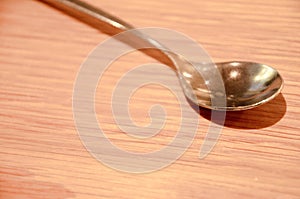 Closeup of a spoon on a wooden table