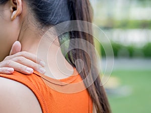 Closeup sport woman feel pain on her neck and shoulder