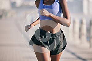 Closeup, sports woman and running motion in sunshine for marathon race, performance and fitness. Female runner, cardio