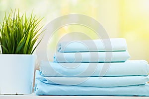 Closeup stack of blue clean bedding on blurred background