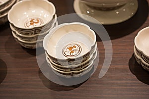 Closeup of stack of ceramic bowls on a wooden table