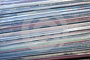 Closeup of stack of old vinyl records in covers