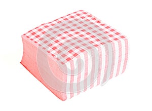 Closeup of a stack of red checked or checkered paper napkins isolated