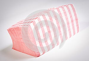 Closeup of a stack of red checked or checkered paper napkins isolated