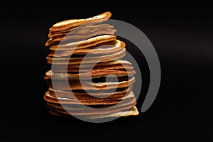Closeup at stack of sliced dried dehydrated oranges at black background