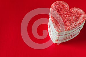 Stacked heart shaped valentines cookies on red background