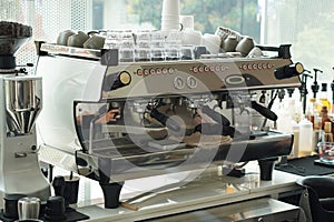 closeup stainless steel electric coffee maker in coffee shop background