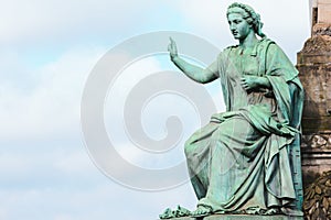 Closeup of the statue of the Congress Column under the sunlight and a cloudy sky in Brussels