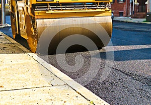 Steamroller compacting asphalt in road repaving project. photo
