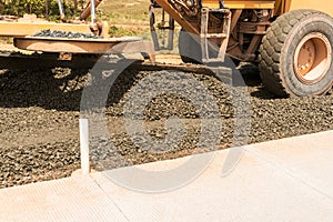 Closeup of a Steamroller spreading asphalt mixture during the construction of a road in Central America