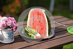 Closeup still life watermelon on brown wooden table with bokeh nature on background