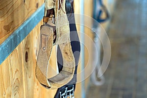 Closeup stirrup riding horse equipment hang on wooden fence