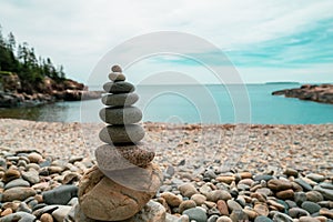 Closeup of a Stone Johnnie on a rocky beach with a scenic waterscape in the background