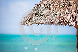 Closeup straw beach umbrella on tropics