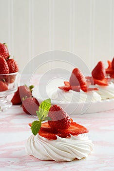 Closeup of strawberries meringue nests with mint