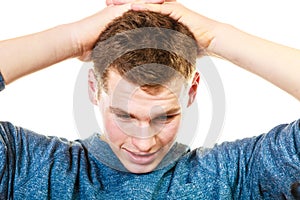 Closeup stressed man holds head with hands