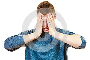 Closeup stressed man holds head with hands