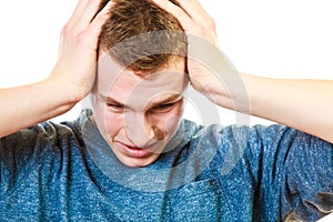 Closeup stressed man holds head with hands