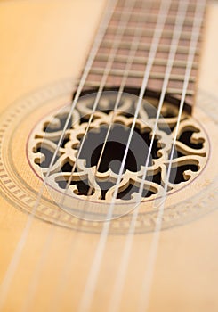 Closeup of strings on old acoustic guitar