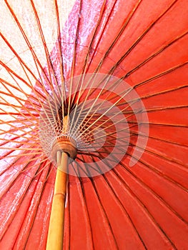 Closeup the structure of the red beach umbrella old made of wooden for protected sunlight