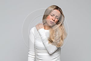 Woman with pain in her neck and back. Cervical arthritis, osteochondrosis, overwork photo