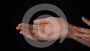 Closeup studio shot of beautiful caucasian woman holding open palm and touching wrist area skin.