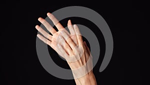 Closeup studio shot of beautiful caucasian woman showing and touching her hands smooth skin.