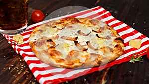 Closeup studio shot hot oven baked tasty delicious Italian homemade ham pineapple traditional Hawaiian bread crust round pizza