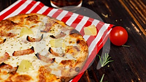 Closeup studio shot hot oven baked tasty delicious Italian homemade ham pineapple traditional Hawaiian bread crust round pizza