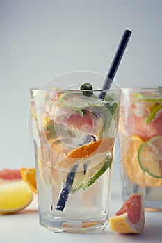 Closeup summer drink. Homemade lemonade, juice or cocktail with sparkling water, citrus fruits. Refreshing cold drink