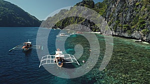 Closeup summer vacation on passenger boats at ocean. Amazing landscape of Philippines cliff shore