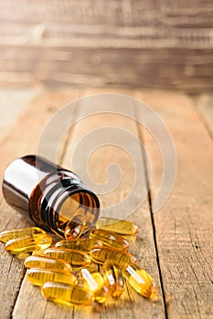 Closeup supplements vitamins bottle on wood background
