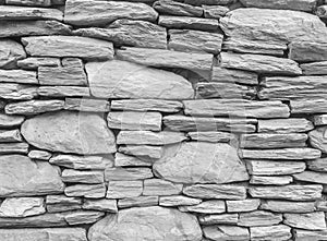Closeup surface brick pattern at old stone brick wall textured background in black and white tone
