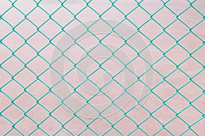 Closeup surface green steel net at the fence of tennis court textured background