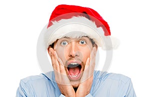 Closeup of surprised businessman wearing christmas hat isolated