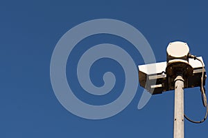Closeup surveillance video camera blue sky