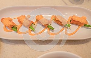 Closeup Sushi roll with fresh salmon In white plate . Japanese style Food