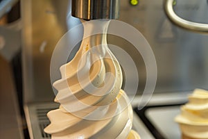 closeup of the swirl of soft serve ice cream being dispensed