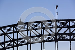 Closeup of Sydney Harbour Bridge at dusk, with bridge climbers