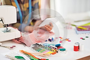 Closeup on tailor woman using tablet pc at work