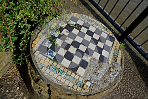Closeup taken from an angle of old outdoor chess table located next to River Thames